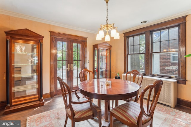4009 Oglethorpe St, Hyattsville, MD 20782 - dining area with french doors, light wood-style flooring, crown molding, a chandelier, and radiator heating unit