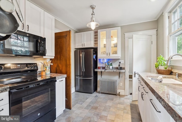 4009 Oglethorpe St, Hyattsville, MD 20782 - kitchen featuring black appliances, radiator heating unit, white cabinetry, glass insert cabinets, and decorative light fixtures