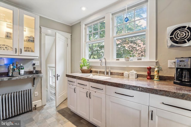 4009 Oglethorpe St, Hyattsville, MD 20782 - kitchen featuring radiator heating unit, white cabinetry, glass insert cabinets, crown molding, and recessed lighting