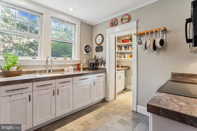 4009 Oglethorpe St, Hyattsville, MD 20782 - kitchen with white cabinets, ornamental molding, black microwave, dark countertops, and recessed lighting