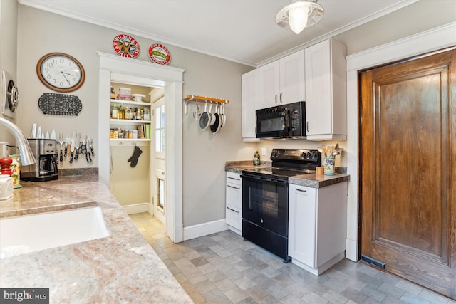 4009 Oglethorpe St, Hyattsville, MD 20782 - kitchen with black appliances, white cabinetry, ornamental molding, stone finish floors, and light countertops