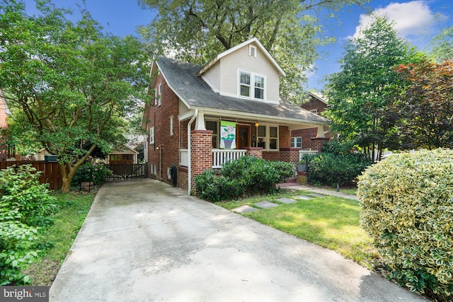 4009 Oglethorpe St, Hyattsville, MD 20782 - bungalow-style house featuring covered porch, concrete driveway, and brick siding
