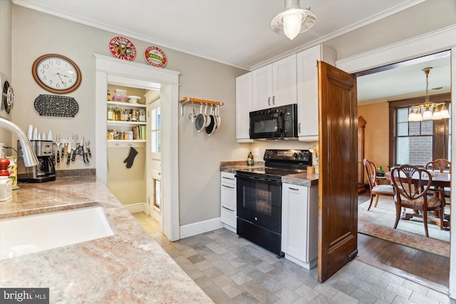 4009 Oglethorpe St, Hyattsville, MD 20782 - kitchen with black appliances, crown molding, white cabinets, light stone finish flooring, and hanging light fixtures