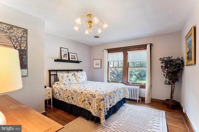 4009 Oglethorpe St, Hyattsville, MD 20782 - bedroom with radiator heating unit, wood finished floors, and a chandelier
