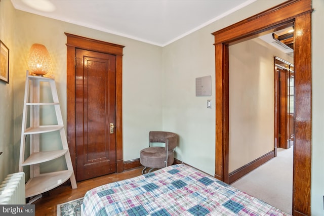 4009 Oglethorpe St, Hyattsville, MD 20782 - bedroom with radiator heating unit, crown molding, and wood finished floors