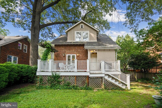 4009 Oglethorpe St, Hyattsville, MD 20782 - rear view of house with a wooden deck, stucco siding, stairs, and roof with shingles