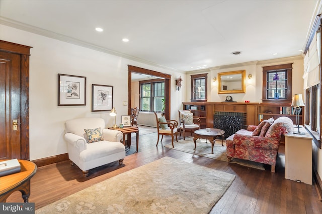 4009 Oglethorpe St, Hyattsville, MD 20782 - living area featuring dark wood-style flooring, crown molding, a fireplace, and recessed lighting