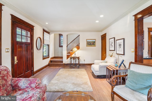 4009 Oglethorpe St, Hyattsville, MD 20782 - living room featuring stairway, hardwood / wood-style flooring, ornamental molding, recessed lighting, and arched walkways