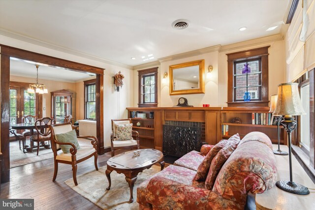 4009 Oglethorpe St, Hyattsville, MD 20782 - living area featuring a fireplace, wood finished floors, crown molding, and recessed lighting