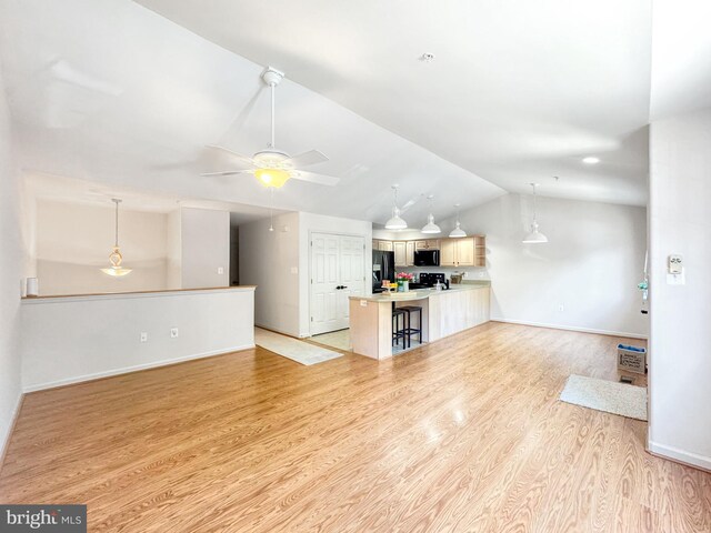 215 Westlake Blvd, Prince Frederick, MD 20678 - unfurnished living room featuring light wood-type flooring, vaulted ceiling, and a ceiling fan