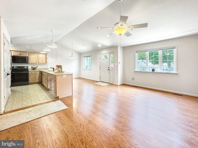 215 Westlake Blvd, Prince Frederick, MD 20678 - kitchen with electric range, light brown cabinetry, healthy amount of natural light, a peninsula, and lofted ceiling