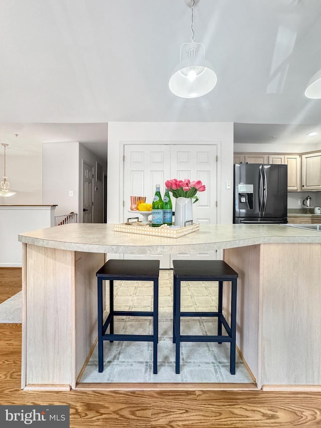 215 Westlake Blvd, Prince Frederick, MD 20678 - kitchen featuring refrigerator with ice dispenser, light countertops, and a kitchen bar
