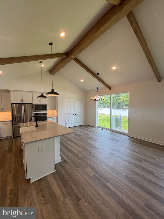 36821 W Old Gate Dr, Georgetown, DE 19947 - kitchen with appliances with stainless steel finishes, light countertops, dark wood-style floors, white cabinets, and open floor plan