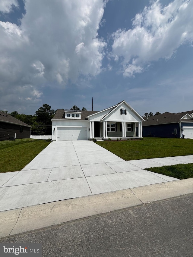 36821 W Old Gate Dr, Georgetown, DE 19947 - modern farmhouse with a front yard, covered porch, concrete driveway, and a garage