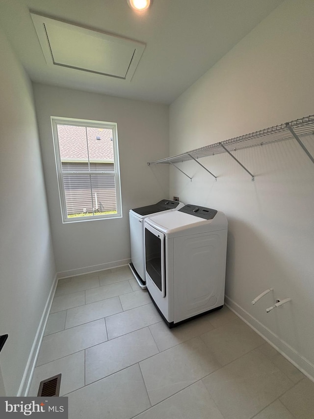36821 W Old Gate Dr, Georgetown, DE 19947 - laundry area with washer and dryer and light tile patterned floors