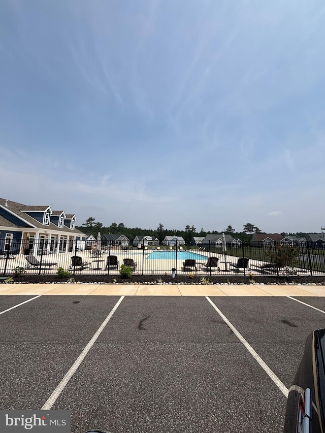 36821 W Old Gate Dr, Georgetown, DE 19947 - uncovered parking lot featuring a community pool