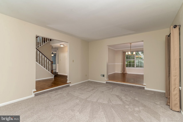 52 Jonquil Way, Sicklerville, NJ 08081 - carpeted empty room featuring stairs and a chandelier