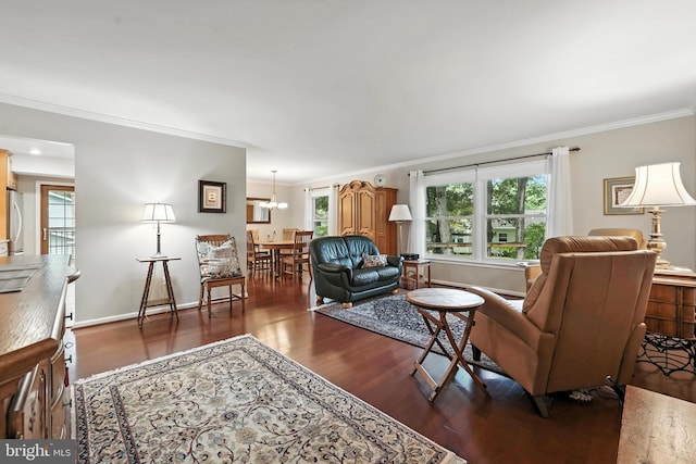 8823 Newport Ct, Springfield, VA 22153 - living room featuring wood finished floors, ornamental molding, healthy amount of natural light, and a chandelier
