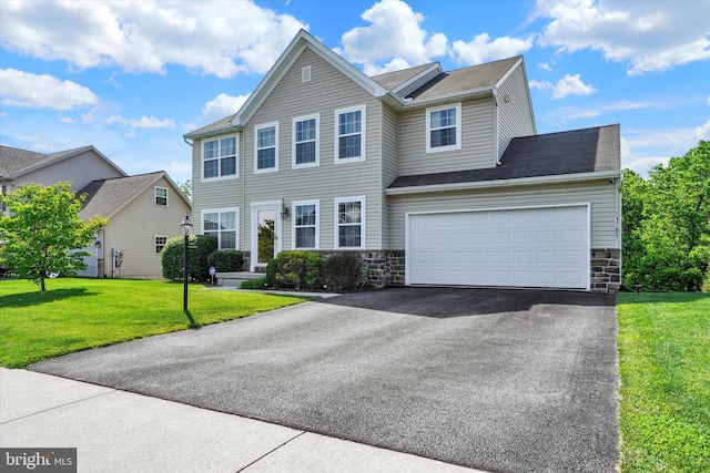 1765 Ivy Pump Ln, York, PA 17408 - view of front facade featuring asphalt driveway, stone siding, a front lawn, and a garage