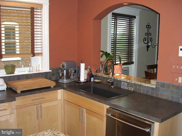 326 W Race, Pottstown, PA 19464 - kitchen featuring dishwasher, dark countertops, decorative backsplash, and arched walkways