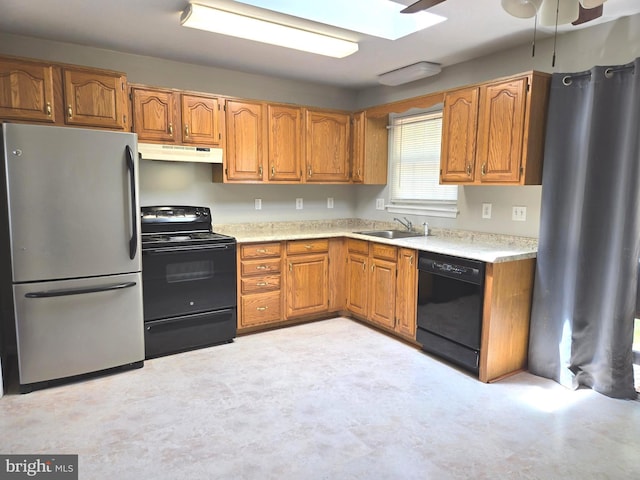 6104 9th St, Chesapeake Beach, MD 20732 - kitchen featuring black appliances, under cabinet range hood, light countertops, brown cabinetry, and a ceiling fan