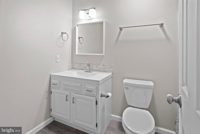 6104 9th St, Chesapeake Beach, MD 20732 - bathroom featuring vanity, wood finished floors, and backsplash