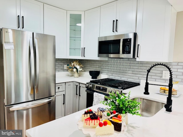 5933 Westridge Ct, Alexandria, VA 22310 - kitchen with stainless steel appliances, light countertops, glass insert cabinets, and white cabinets