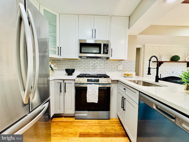 5933 Westridge Ct, Alexandria, VA 22310 - kitchen featuring stainless steel appliances, light countertops, white cabinetry, and light wood-type flooring