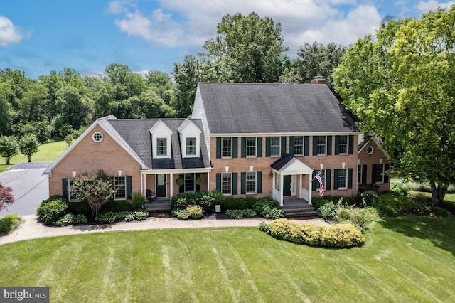 872 The Old Station Ct, Woodbine, MD 21797 - view of front of property with brick siding, a front lawn, and roof with shingles