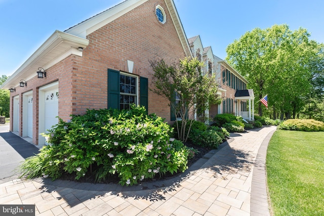 872 The Old Station Ct, Woodbine, MD 21797 - view of home's exterior featuring brick siding, a garage, and a lawn