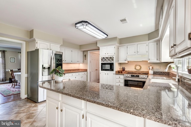 872 The Old Station Ct, Woodbine, MD 21797 - kitchen with stainless steel refrigerator with ice dispenser, range, black microwave, under cabinet range hood, and dark stone countertops