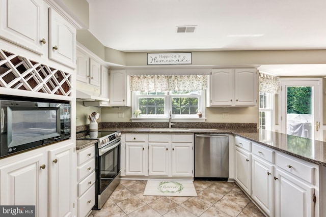 872 The Old Station Ct, Woodbine, MD 21797 - kitchen featuring stainless steel appliances, white cabinetry, dark stone counters, and light tile patterned flooring