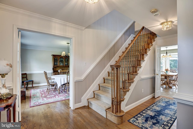 872 The Old Station Ct, Woodbine, MD 21797 - stairs featuring a chandelier, wood finished floors, and ornamental molding