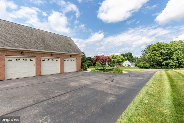 872 The Old Station Ct, Woodbine, MD 21797 - view of property exterior with brick siding, roof with shingles, a garage, and a lawn