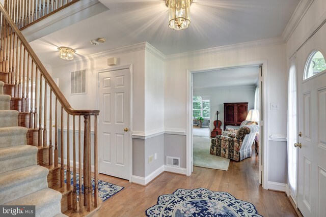 872 The Old Station Ct, Woodbine, MD 21797 - foyer entrance with stairs, plenty of natural light, a chandelier, and crown molding