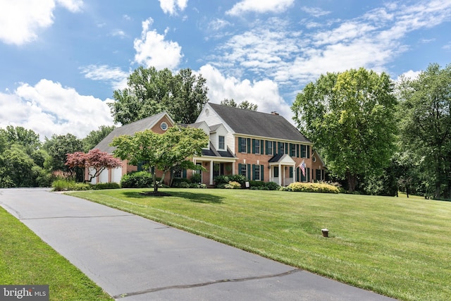 872 The Old Station Ct, Woodbine, MD 21797 - colonial inspired home featuring a front yard, an attached garage, and driveway