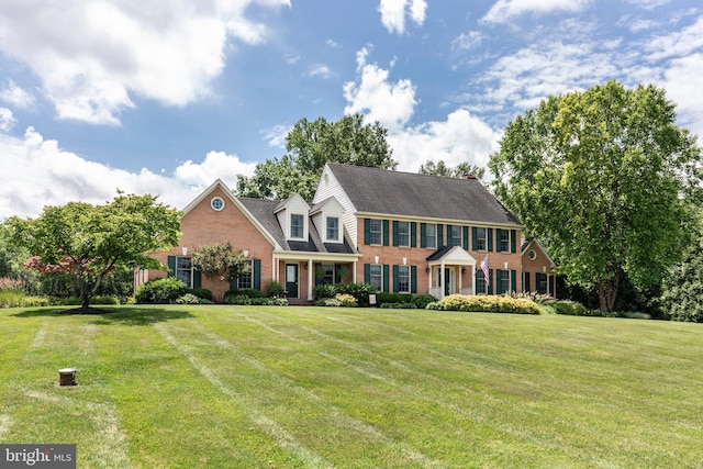 872 The Old Station Ct, Woodbine, MD 21797 - view of front of home with brick siding, a front yard, and a shingled roof