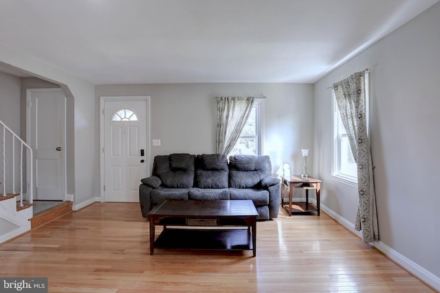 159 Garden Ridge Rd, Catonsville, MD 21228 - living room featuring light wood-type flooring, stairs, and arched walkways