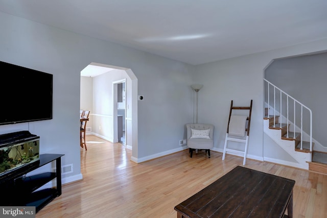 159 Garden Ridge Rd, Catonsville, MD 21228 - sitting room with arched walkways, wood finished floors, and stairs