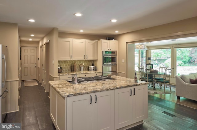 7028 Ely Rd, New Hope, PA 18938 - kitchen featuring appliances with stainless steel finishes, plenty of natural light, white cabinets, light stone counters, and recessed lighting