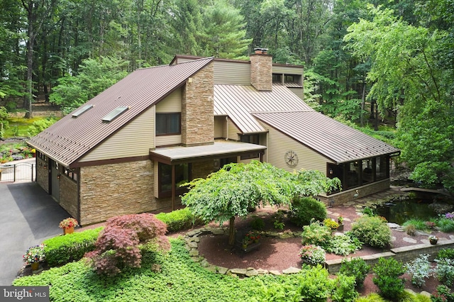 7028 Ely Rd, New Hope, PA 18938 - view of front of property with a chimney, stone siding, a standing seam roof, a metal roof, and a sunroom