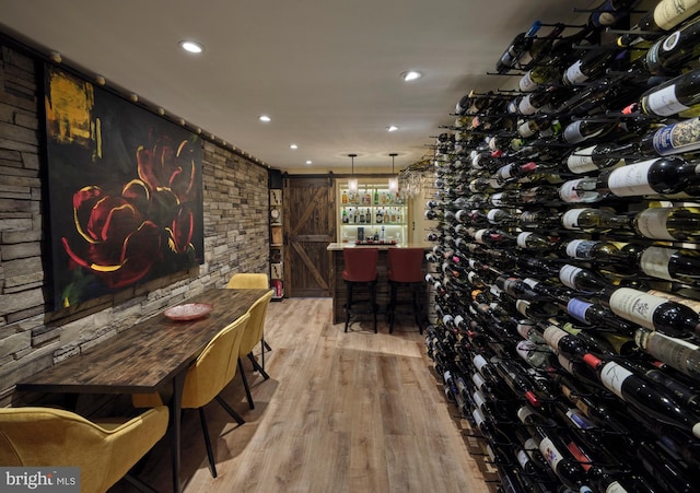 7028 Ely Rd, New Hope, PA 18938 - wine room with a barn door, light wood-style flooring, and recessed lighting