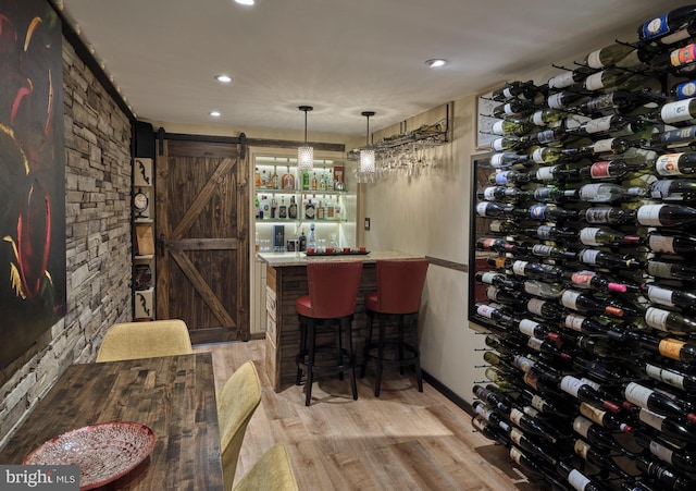 7028 Ely Rd, New Hope, PA 18938 - wine room with a barn door, recessed lighting, light wood finished floors, and a community bar