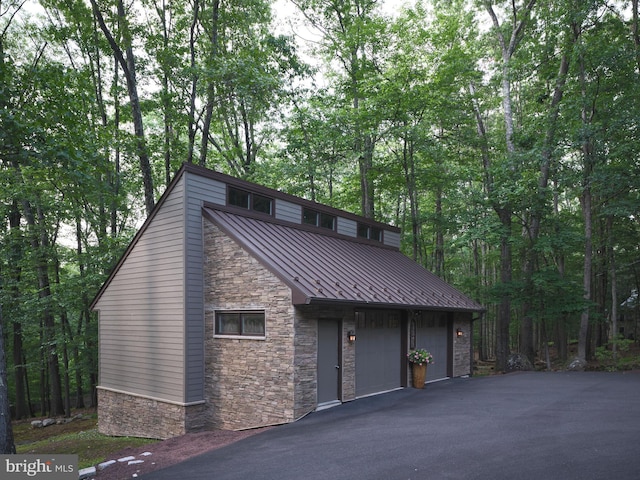 7028 Ely Rd, New Hope, PA 18938 - garage with driveway and a forest view