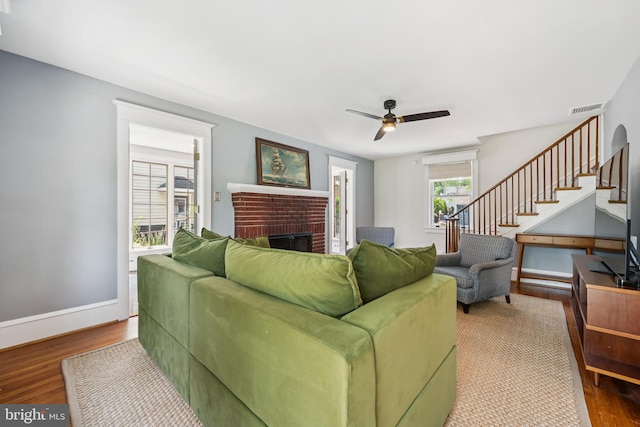 257 Merion Ave, Haddonfield, NJ 08033 - living room with wood finished floors, a fireplace, stairs, and a ceiling fan