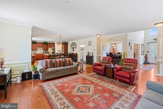 4479 Coachmans Path Ct, Waldorf, MD 20601 - living area with light wood-style floors, ornamental molding, a chandelier, and recessed lighting