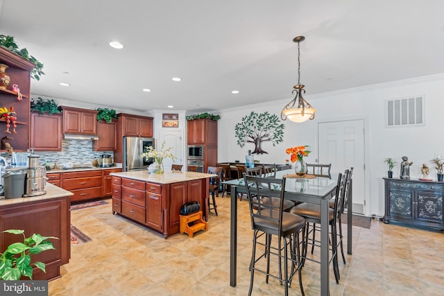 4479 Coachmans Path Ct, Waldorf, MD 20601 - kitchen with appliances with stainless steel finishes, ornamental molding, decorative light fixtures, tasteful backsplash, and a kitchen island