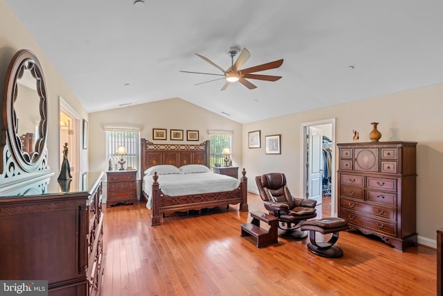 4479 Coachmans Path Ct, Waldorf, MD 20601 - bedroom featuring lofted ceiling, light wood-style flooring, a spacious closet, multiple windows, and ceiling fan