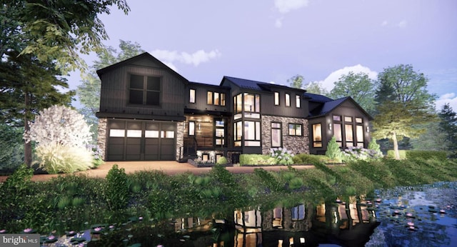 2468 River Rd, New Hope, PA 18938 - view of front facade featuring stone siding, dirt driveway, and a garage