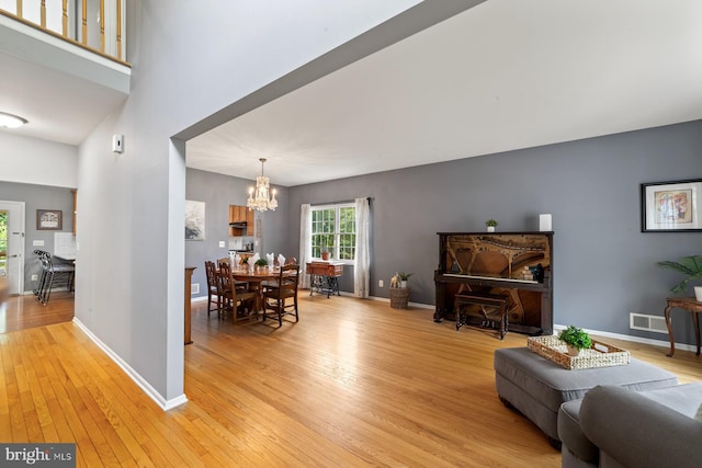 114 Ketterer Ct, Lawrence, NJ 08648 - dining room featuring a chandelier, light wood-type flooring, and a towering ceiling